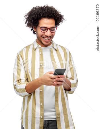 happy smiling man in glasses with smartphone 92166270
