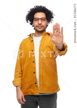 man in glasses and yellow jacket making stop gesture 92166271