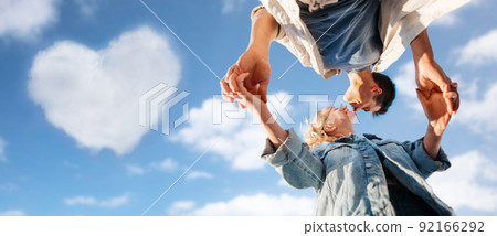 happy young couple holding hands under blue sky happy young couple holding hands under blue sky 92166292