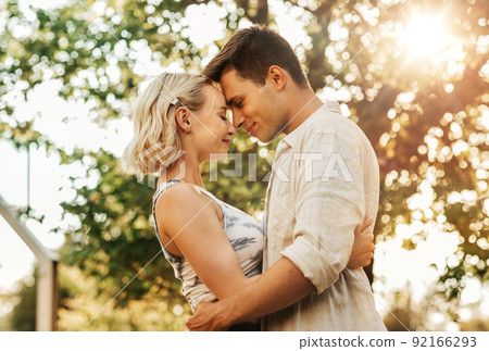happy young couple hugging outdoors happy young couple hugging outdoors 92166293