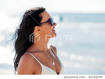smiling young woman in bikini swimsuit on beach smiling young woman in bikini swimsuit on beach 92166294