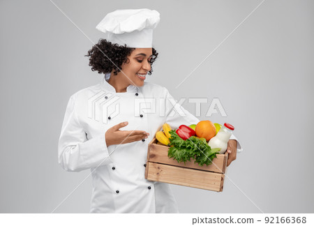 happy smiling female chef with food in wooden box happy smiling female chef with food in wooden box 92166368