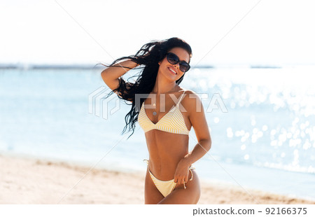 smiling young woman in bikini swimsuit on beach smiling young woman in bikini swimsuit on beach 92166375