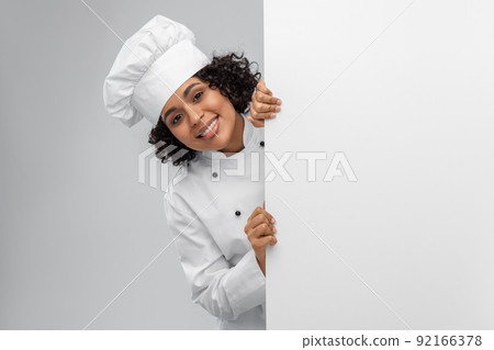 smiling female chef with white board smiling female chef with white board 92166378