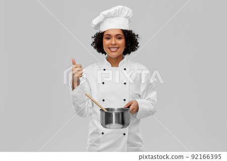female chef with saucepan and spoon cooking food 92166395