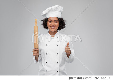 smiling female chef or baker with rolling pin smiling female chef or baker with rolling pin 92166397