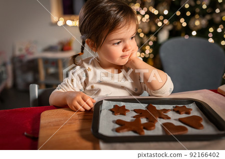 little girl with gingerbread cookies on christmas 92166402