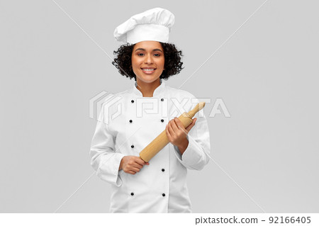 smiling female chef or baker with rolling pin 92166405