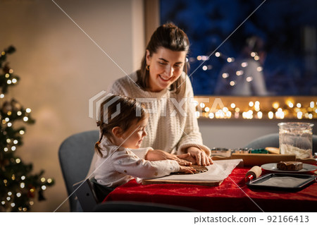 mother and daughter making gingerbread at home mother and daughter making gingerbread at home 92166413