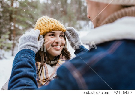 couple looking at each other in winter forest couple looking at each other in winter forest 92166439