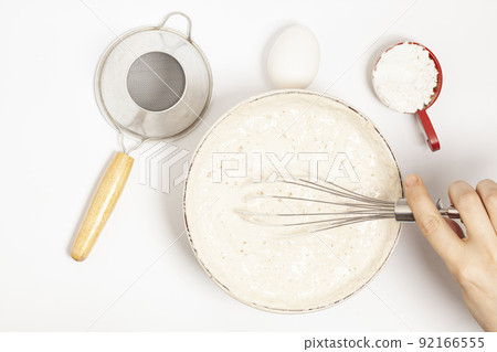 MIxing baking ingredients with dry yeast isolated on white background MIxing baking ingredients with dry yeast isolated on white background 92166555