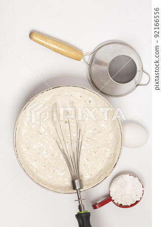 MIxing baking ingredients with dry yeast isolated on white background MIxing baking ingredients with dry yeast isolated on white background 92166556