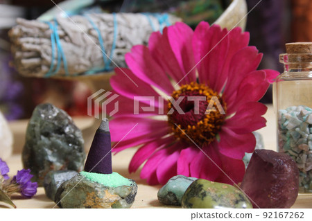 Incense Cone on Stone Slab With Crystals and Flowers 92167262