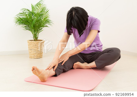 Middle woman stretching indoors 92169954