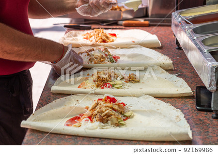 Hands of a professional chef who makes Shawarma 92169986