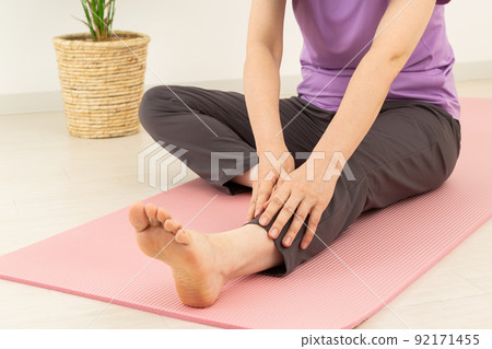 Middle woman stretching indoors 92171455