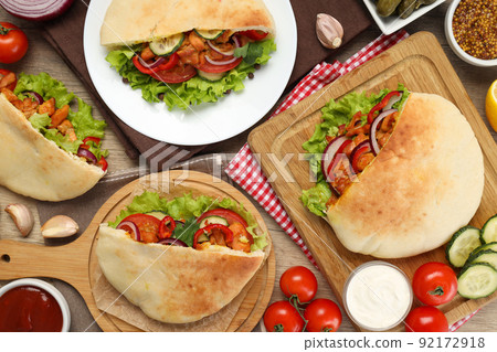 Concept of cooking pita with chicken on wooden background Concept of cooking pita with chicken on wooden background 92172918