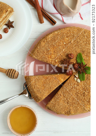 Concept of tasty dessert with honey cake, top view Concept of tasty dessert with honey cake, top view 92173323