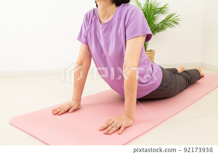 Middle woman stretching indoors 92173938