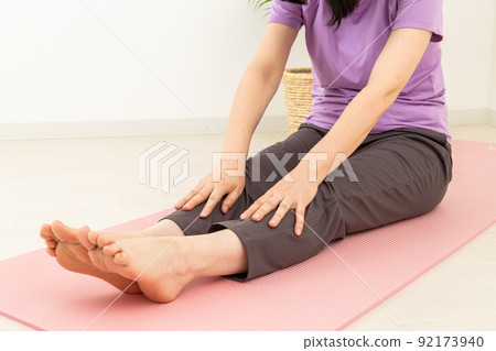 Middle woman stretching indoors 92173940