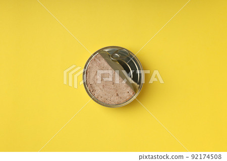 Tin can of pate on yellow background 92174508