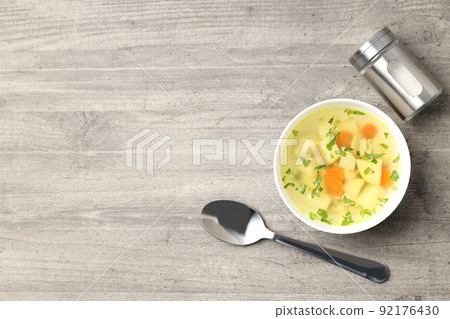 Concept of tasty food with chicken soup on gray textured background Concept of tasty food with chicken soup on gray textured background 92176430