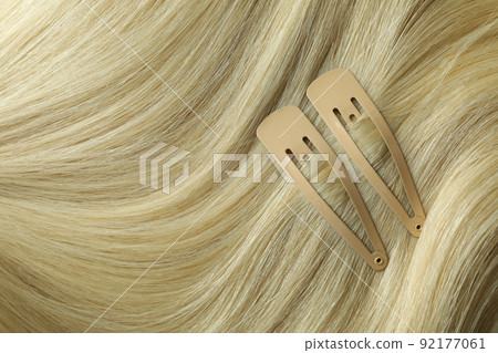 Female hair with hair clips on whole background Female hair with hair clips on whole background 92177061