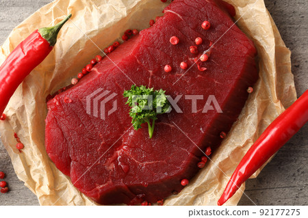 Concept of tasty food with raw beef steak, close up Concept of tasty food with raw beef steak, close up 92177275