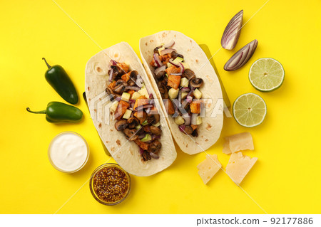 Concept of tasty food with taco on yellow background 92177886