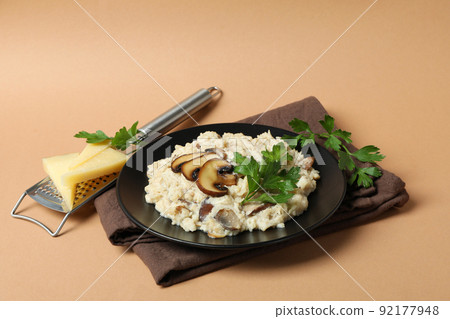 Concept of tasty food with risotto with mushrooms on beige background 92177948
