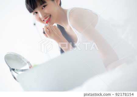 Beauty of young asian woman with learning makeup with lipstick on mouth watching laptop computer. Beauty of young asian woman with learning makeup with lipstick on mouth watching laptop computer. 92178154