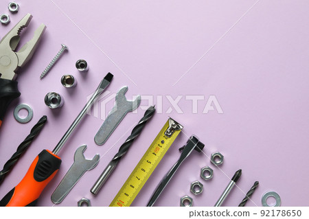 Work tools on purple background, top view Work tools on purple background, top view 92178650