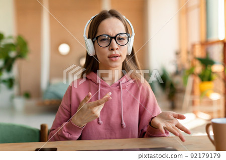 Portrait of schoolgirl learning distantly during virtual remote class, participating in online lesson, webcam pov Portrait of schoolgirl learning distantly during virtual remote class, participating in online lesson, webcam pov 92179179