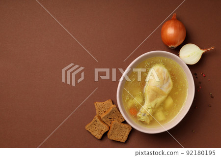 Concept of tasty food with chicken soup on brown background Concept of tasty food with chicken soup on brown background 92180195