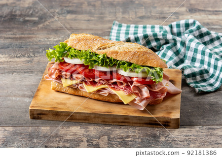 Submarine sandwich with ham, cheese, lettuce, tomatoes,onion, mortadella and sausage Submarine sandwich with ham, cheese, lettuce, tomatoes,onion, mortadella and sausage 92181386