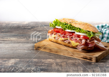 Submarine sandwich with ham, cheese, lettuce, tomatoes,onion, mortadella and sausage Submarine sandwich with ham, cheese, lettuce, tomatoes,onion, mortadella and sausage 92181388