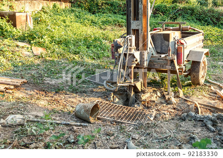 Rotary drilling rig at a construction site.Sludge flow from the joule during the water well drilling 92183330