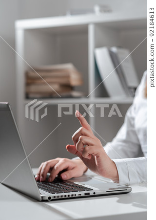 Businesswoman Typing Recent Updates On Lap Top Keyboard On Desk And Pointing Important Ideas With One Finger. Woman In Office Writing Late Messages On Computer. Businesswoman Typing Recent Updates On Lap Top Keyboard On Desk And Pointing Important Ideas With One Finger. Woman In Office Writing Late Messages On Computer. 92184613