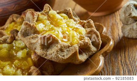 Karelian pasty with apples and apricot Karelian pasty with apples and apricot 92185083