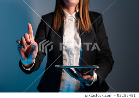 Businesswoman Holding Phone And Pointing With One Finger On Important Message On Desk With Lap Top. Executive In Suit Presenting Crutial Informations. Businesswoman Holding Phone And Pointing With One Finger On Important Message On Desk With Lap Top. Executive In Suit Presenting Crutial Informations. 92185481