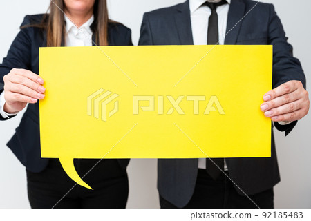 Business Team Holding Important Information On Speech Bubble On Both Sides. Executives Presenting Crutial Messages On Dialogue Balloon. Man And Woman Showing Recent Ideas. Business Team Holding Important Information On Speech Bubble On Both Sides. Executives Presenting Crutial Messages On Dialogue Balloon. Man And Woman Showing Recent Ideas. 92185483