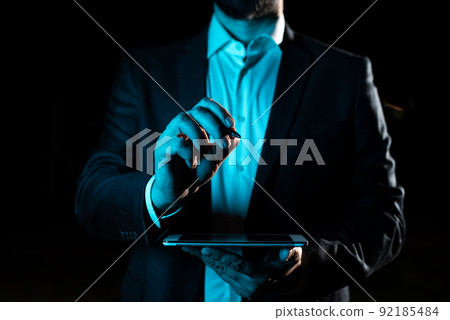 Hand With Pen Pointing Important Infortmations With Other Holding Tablet. Businessman Presenting Recent Updates. Executive Displaying Critical Messages. Hand With Pen Pointing Important Infortmations With Other Holding Tablet. Businessman Presenting Recent Updates. Executive Displaying Critical Messages. 92185484