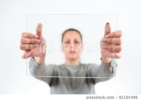 Female Professional Holding Transparent Glass And Displaying Important Data. Woman Wearing Smart Casual Showing Banner While Promoting The Business For Progress. Female Professional Holding Transparent Glass And Displaying Important Data. Woman Wearing Smart Casual Showing Banner While Promoting The Business For Progress. 92185498