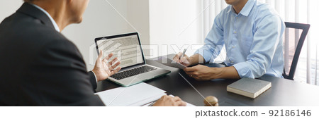Lawyer and justice concept, Businessman takes notes as senior lawyer explain detail of the contract Lawyer and justice concept, Businessman takes notes as senior lawyer explain detail of the contract 92186146