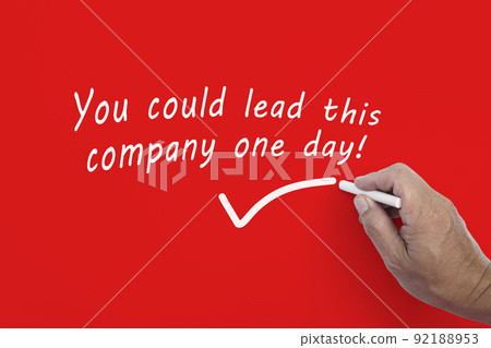 Hand writes in white chalk pencil the word YOU COULD LEAD THIS COMPANY ONE DAY. Hand writes in white chalk pencil the word YOU COULD LEAD THIS COMPANY ONE DAY. 92188953