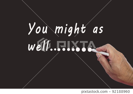 Male hand writes in white chalk pencil the word YOU MIGHT AS WELL. Male hand writes in white chalk pencil the word YOU MIGHT AS WELL. 92188960
