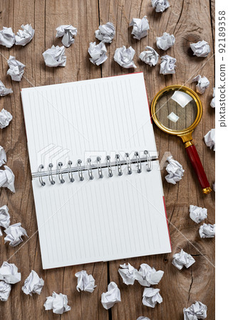 Notepad Opened On Both Pages With Important Data Written In With Paper Wraps And Magnifier Around. Notebook On Ground With Crutial News Inside And Crumpled Notes All Over. Notepad Opened On Both Pages With Important Data Written In With Paper Wraps And Magnifier Around. Notebook On Ground With Crutial News Inside And Crumpled Notes All Over. 92189358