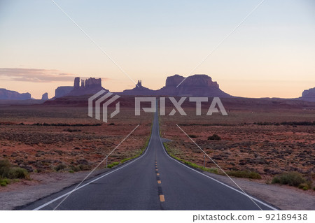 Scenic Road in the Dry Desert with Red Rocky Mountains in Background. Scenic Road in the Dry Desert with Red Rocky Mountains in Background. 92189438