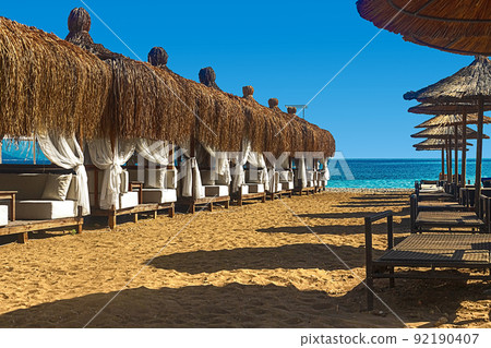 View of deck chairs and umbrellas on the sandy beach of Kemer, Turkey. View of deck chairs and umbrellas on the sandy beach of Kemer, Turkey. 92190407