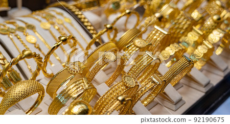 Golden luxury bracelets on stand in jewelry shop Golden luxury bracelets on stand in jewelry shop 92190675